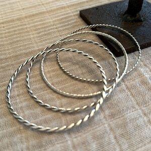 Set of z4 stacked silver bangle bracelets